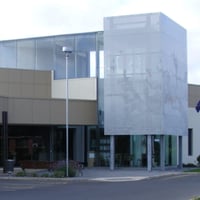 The outside of a modern building with square architecture features.